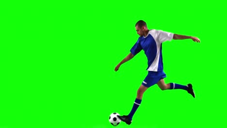 athlete practicing soccer against green screen