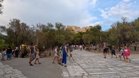 visitors walking around the parthenon in athens