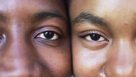 a close-up captures a diverse couple, their eyes in focus