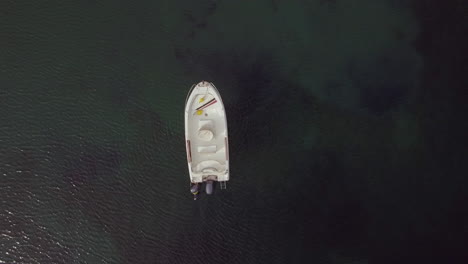 Flying-over-the-lonely-motor-boat-in-vast-blue-sea