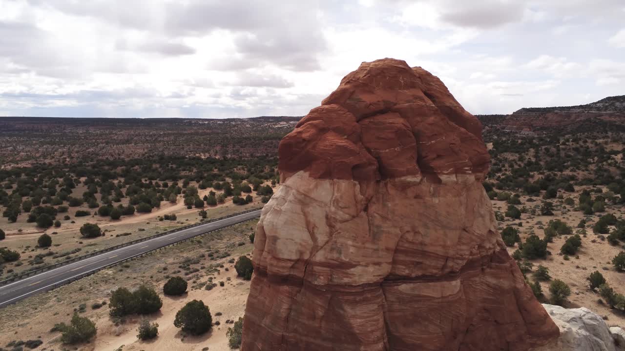 Aerial View of Red Rock Butte Tower Formations and Arizona State Route Highway in Arid Desert Landscape
