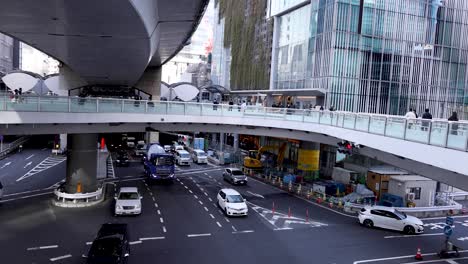 vehicles and pedestrians navigating a busy intersection