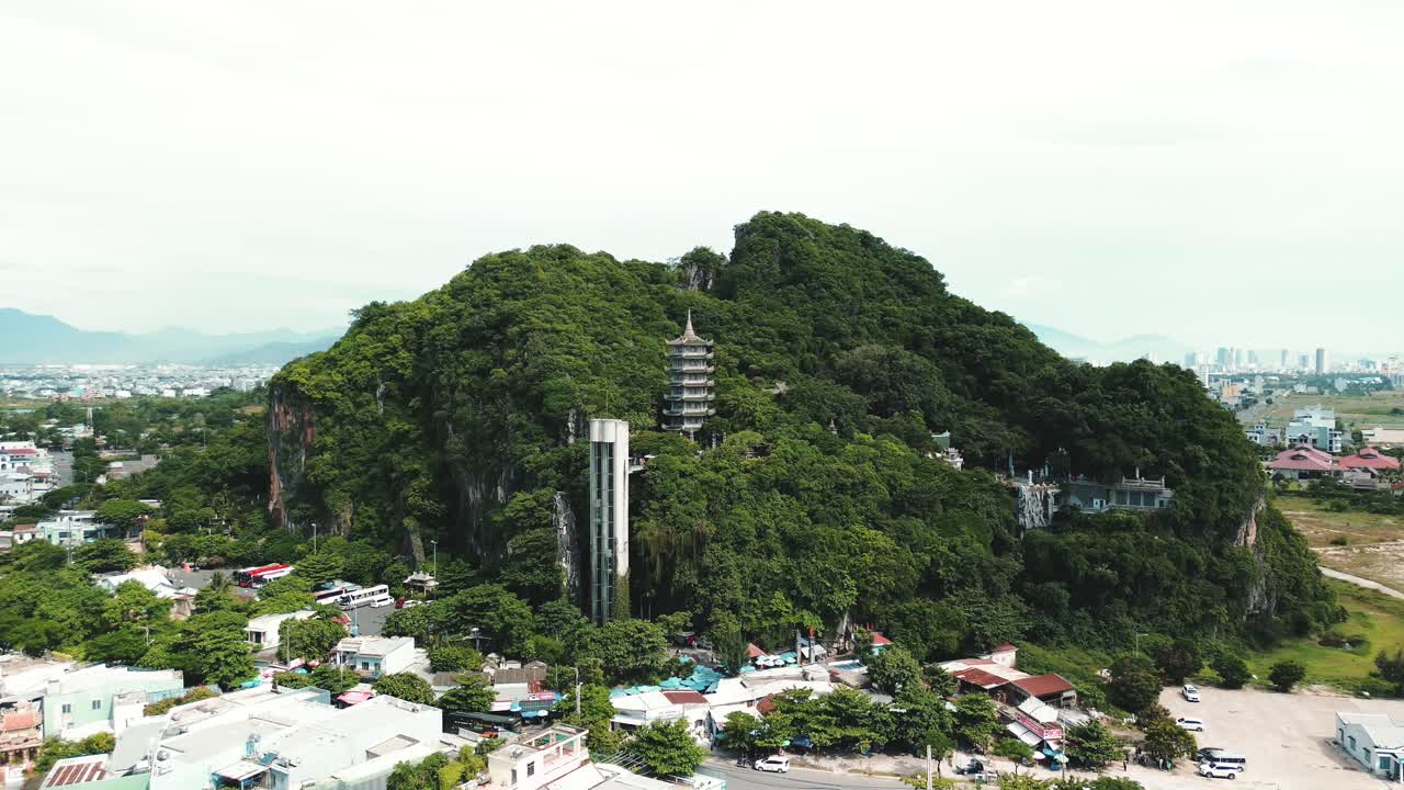 Limestone peaks of Marble Mountains in Da Nang, Vietnam, aerial establishing orbit