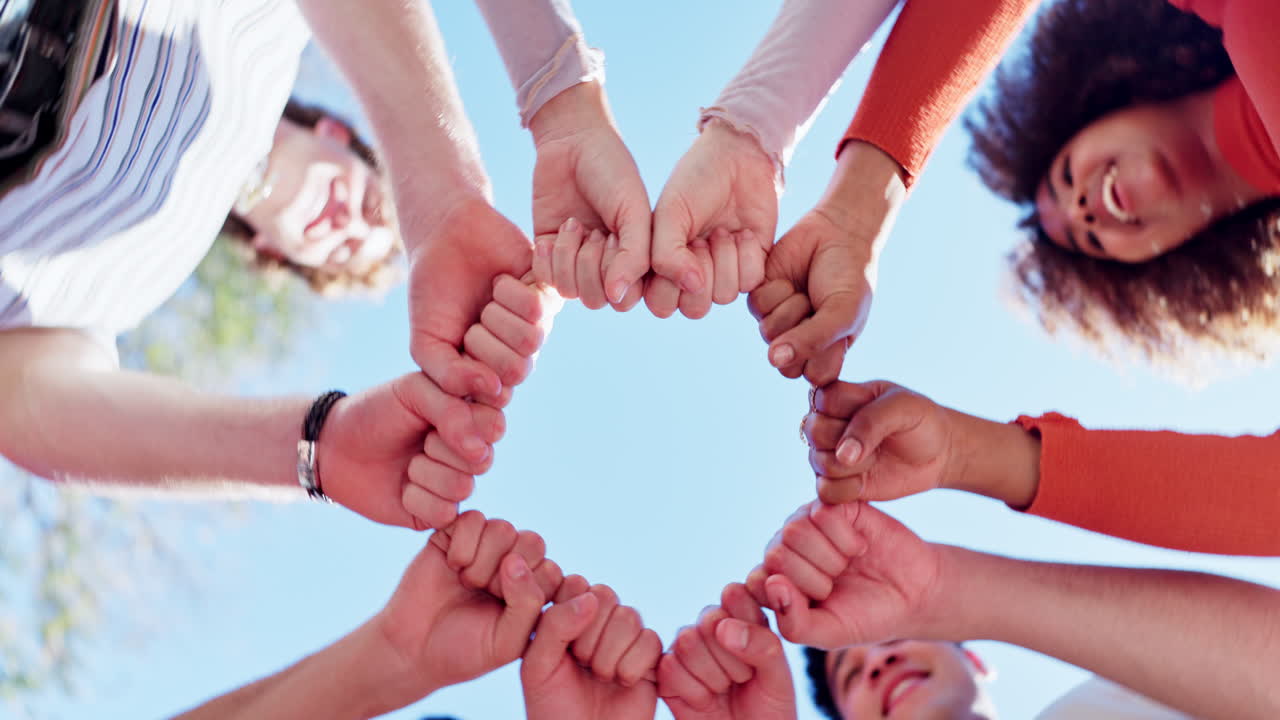 Group of people joining hands in a circle