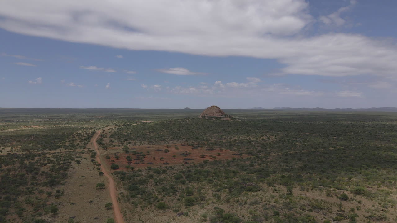 breathtaking drone view of a Jeep navigating Namibia's vast landscapes, showcasing stunning deserts, rugged terrain, and endless horizons in an epic adventure through nature's beauty.