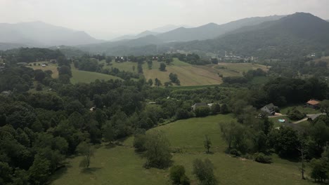 bucolic flyover of meadows and fields in smoky appalachia mountains