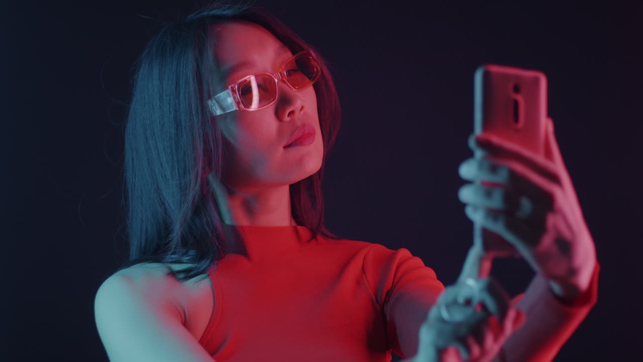 Woman taking a selfie in neon light