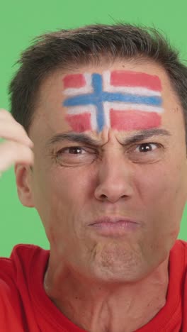 man with norwegian national flag upset with a referee