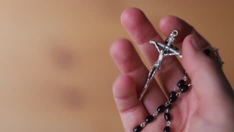 Hand-holding-rosary-necklace