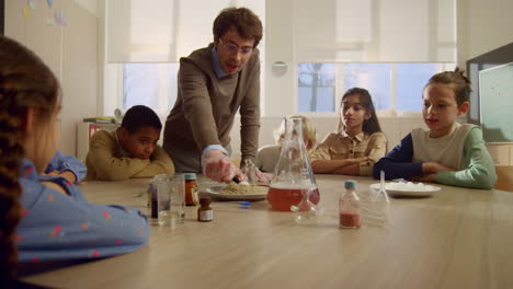 Male-teacher-of-chemistry-setting-fire-to-chemicals-during-lesson-at-school