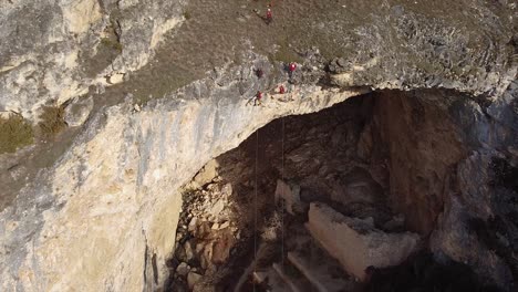 Rock-climbers-hanging-from-a-tall-cliff-drone-shot