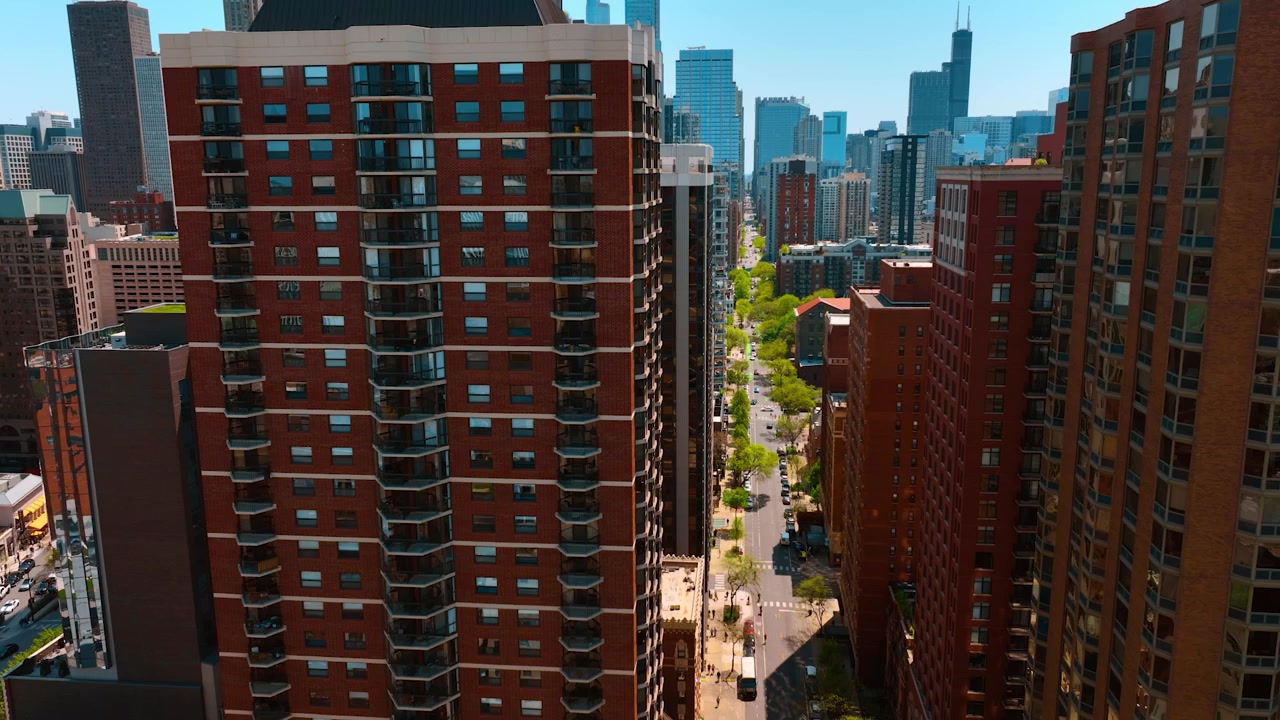 Footage at the high-rise buildings with brown facades in the downtown of Chicago, Illinois, USA. Fantastic skyscrapers at backdrop.