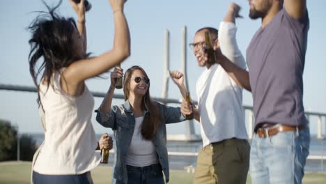 Laughing-company-jumping-with-beer-bottle.