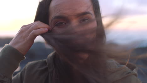 a young woman removing hair from her face