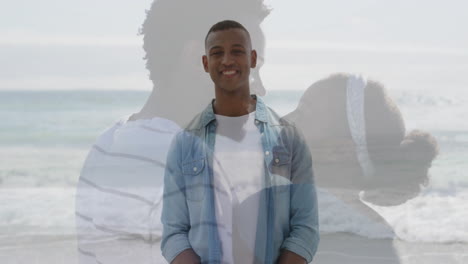 at beach, man smiling with animation of couple embracing by sea