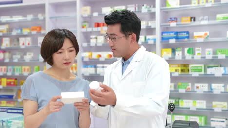 cheerful friendly pharmacist ready to advise patients or sell medication, laughing while standing in front of shelves of medicine, working at a pharmacy of a hospital or clinic