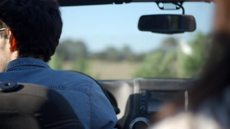 young man driving a car, rear passenger point of view