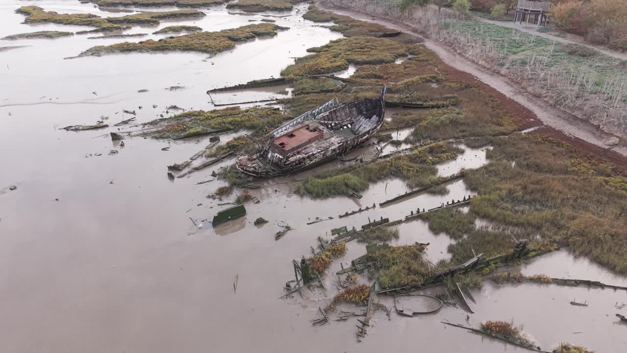 Aerial view overlooking Blackwater river Essex mudflat shipwreck stuck in low tide salt marsh coast