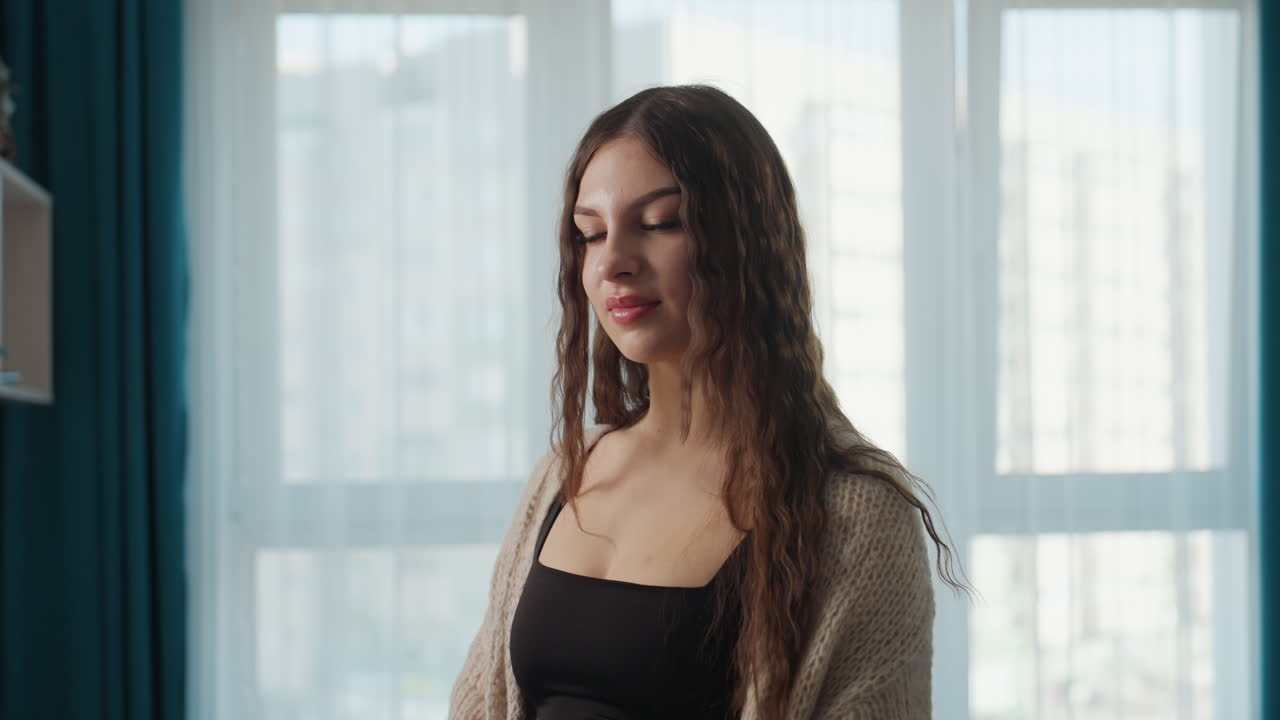 Woman With Calm Expression Illuminated By Window, Portrait Of Tranquil Woman Bathed In Gentle Light, Serene Female Subject Depicted In Atmospheric Lighting Featuring Natural Makeup And Graceful Stance