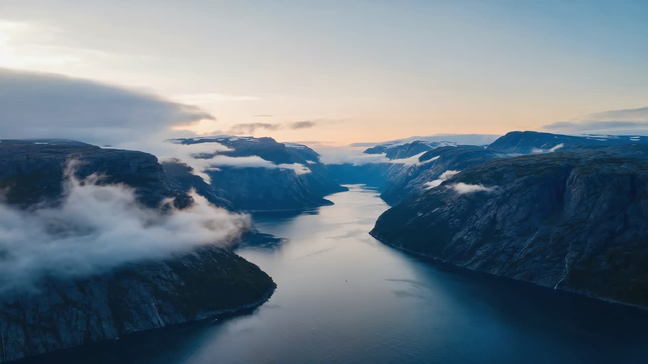 Aerial view of a fjord in Norway with mountains and clouds