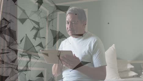 animation of network of connections spinning over senior man using tablet at home
