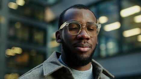 man in glasses in an urban setting