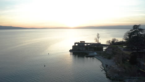 Aerial-of-boat-docks-on-lake-at-sunset