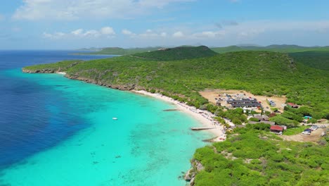 drone descends tilting up as clouds pass over playa porto mari curacao, caribbean