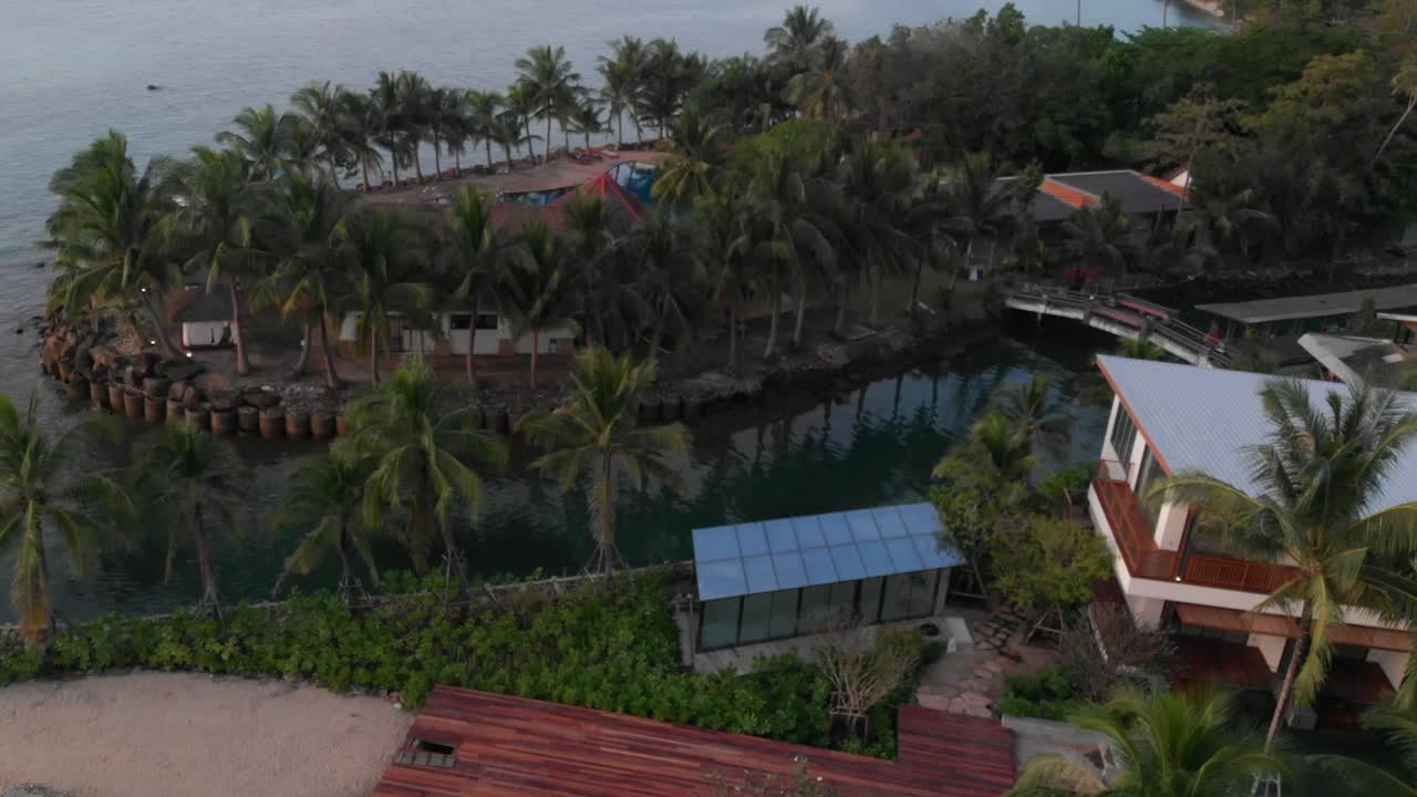 Drone flying along the coast of Thailand, capturing turquoise waters, sandy beaches, and coastal scenery from above