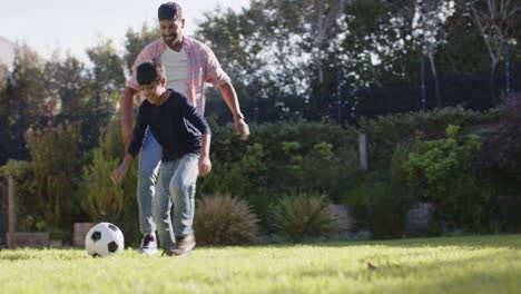 playing soccer in backyard, indian father and son enjoying quality time together