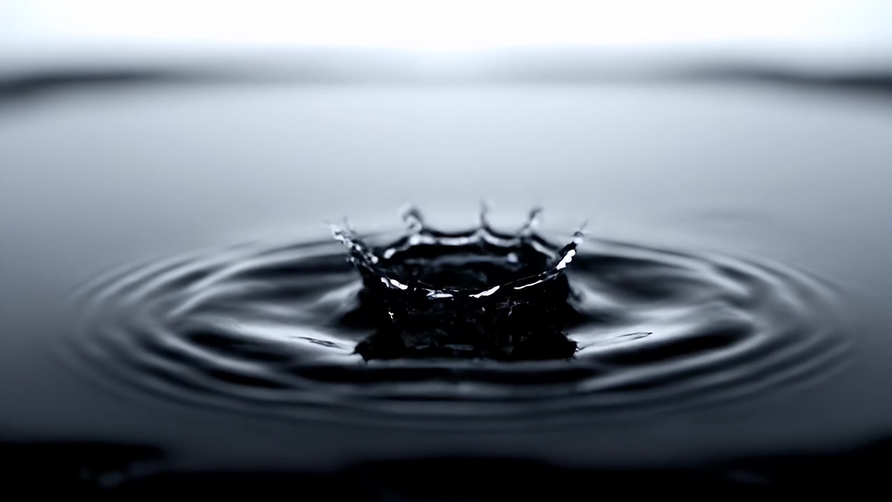 Macro Shot of Water Droplets Creating Ripples and Crowns