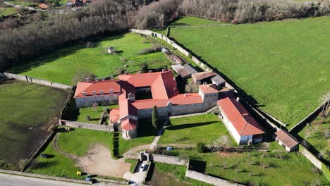 high angle aerial overview of sprawling monastery buildins in rural countryside of spain