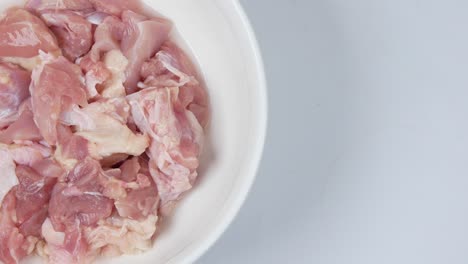 Overhead-view-of-raw-red-meat-in-a-bowl-on-table