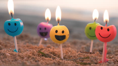 smiley candles on the beach