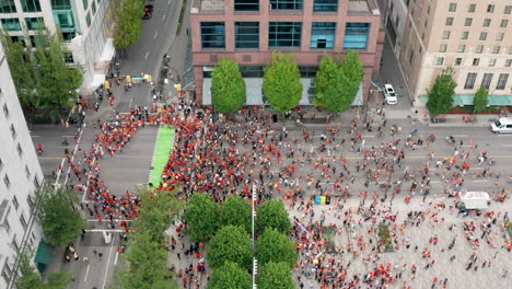 native people block west georgia street at a cancel canada day protest in vancouver bc canada, tilt up sinking drone view in uhd