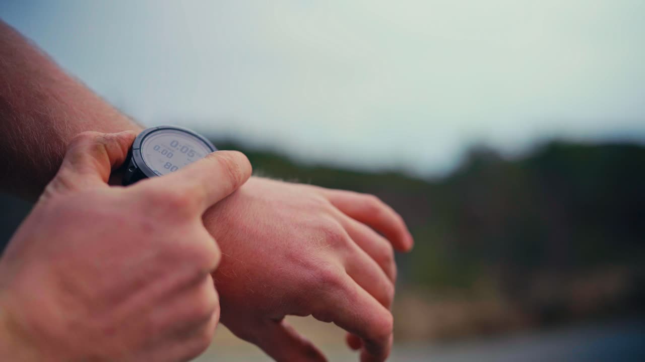 A Hiker Checks His Rugged GPS Smartwatch for Elevation Data During an Outdoor Adventure at Reinsjøen in Åfjord, Trøndelag, Norway - Close Up