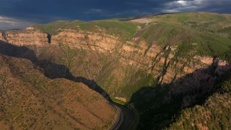 glenwood springs glenwood canyon scenic drive i70 colorado river aerial drone summer traffic sun grand mesa cliffside flat top hanging lake late afternoon dark rain thunderstorm cloudy circle right