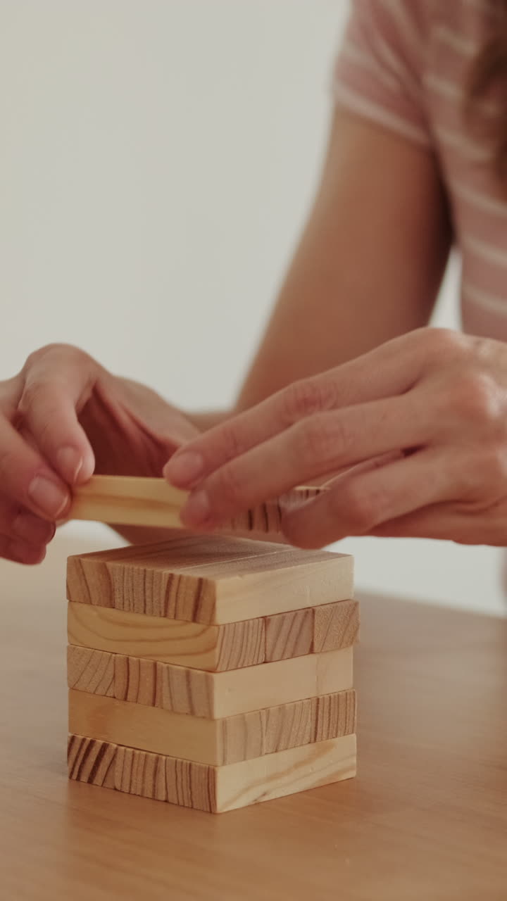 Woman Builds Tower At Home With Blocks
