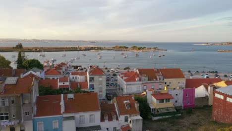 aerial-shot-through-trees-over-seixal-bay-and-buildings---Portugal