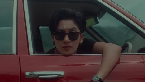 man in a red car