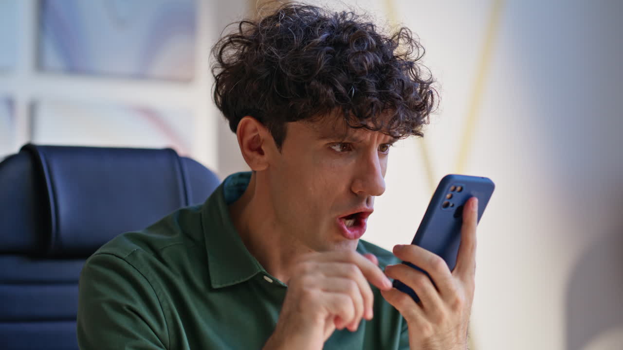 Stressed manager shouting cellphone complaining on failure at office closeup