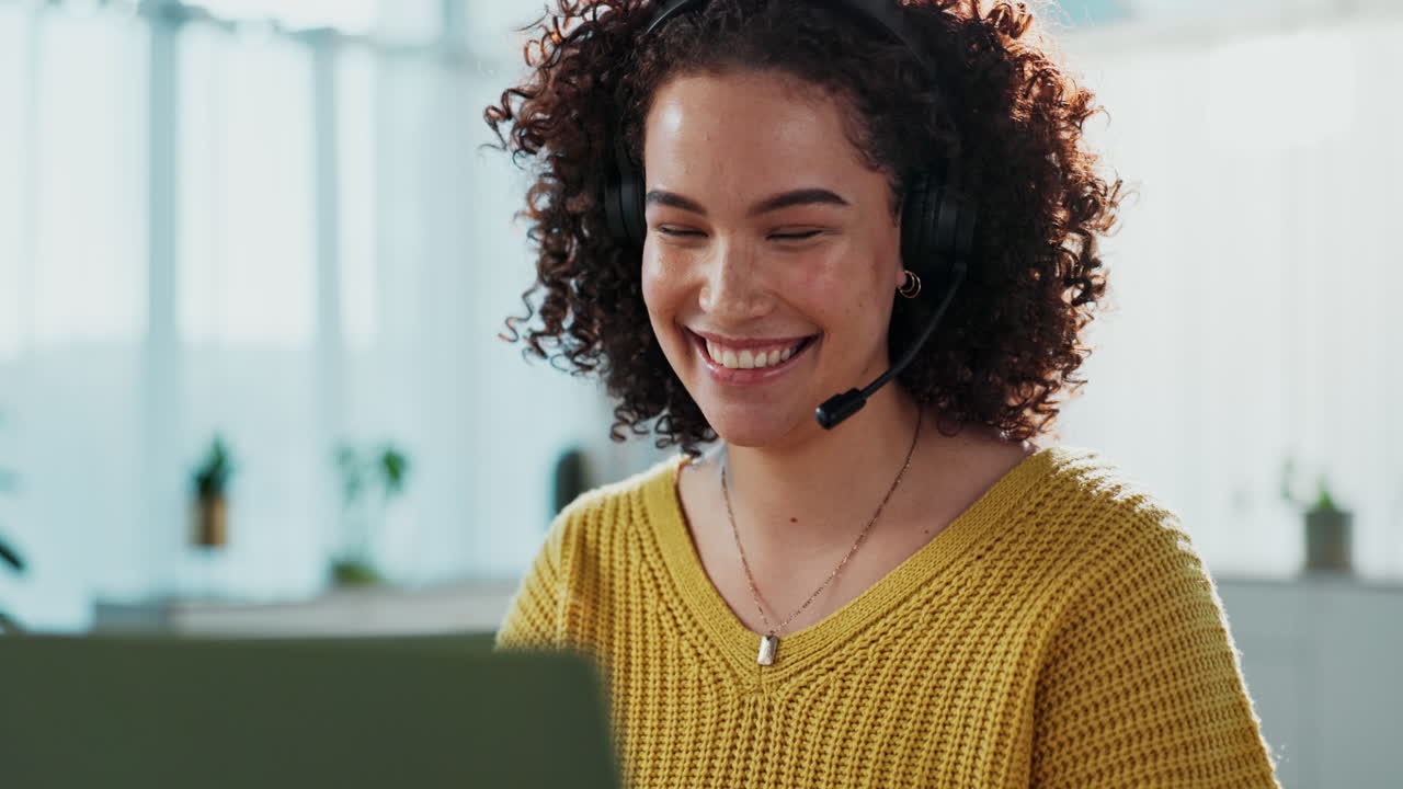 Donna che lavora in un call center con cuffie e computer