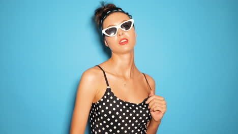 woman in retro swimsuit and sunglasses