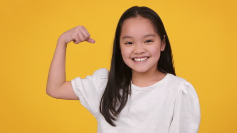 proud girl showing biceps