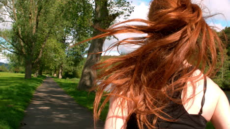 fit redhead jogging along path outside