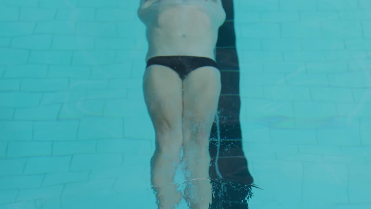 Swimmer swimming into the pool