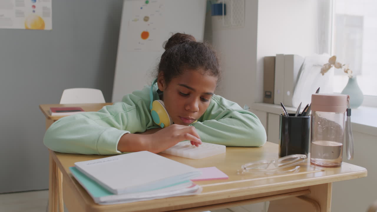 Girl Playing Sensory Fidget Toy in Classroom