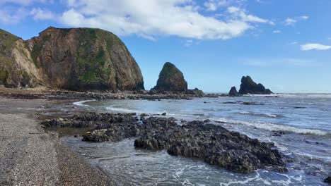 Tranquil-lagoon-rocky-shore-pebble-beach-and-cliffs-with-tidal-erosion-Copper-Coast-Waterford-Ireland