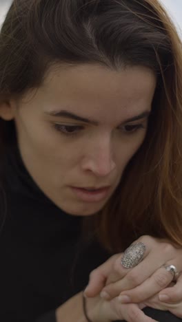 close-up portrait of a pensive woman looking down