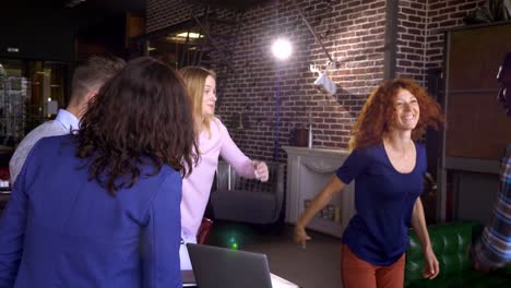 happy team dancing in the office